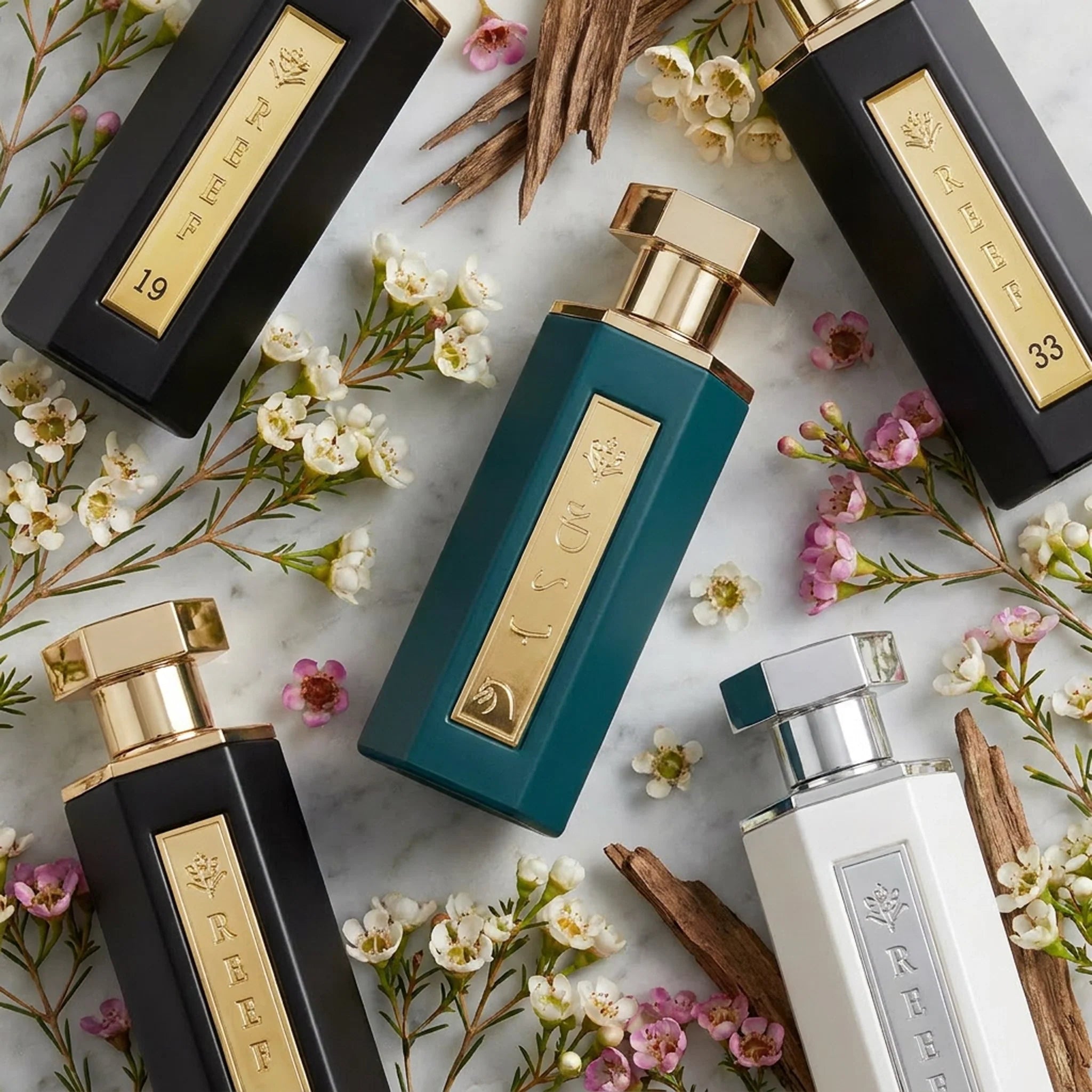 Collection of Reef 100ml Perfumes surrounded by plants