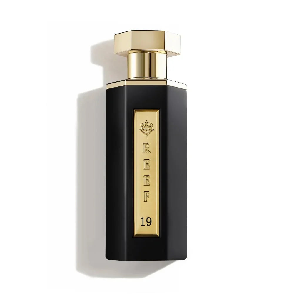 Reef - 19 100ml perfume bottle with gold cap and label on a white background