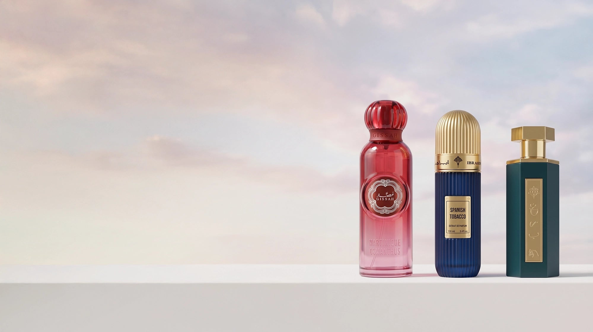 Reef, Ibraq, & Gissah perfumes. Three perfume bottles of different colors on a gradient background